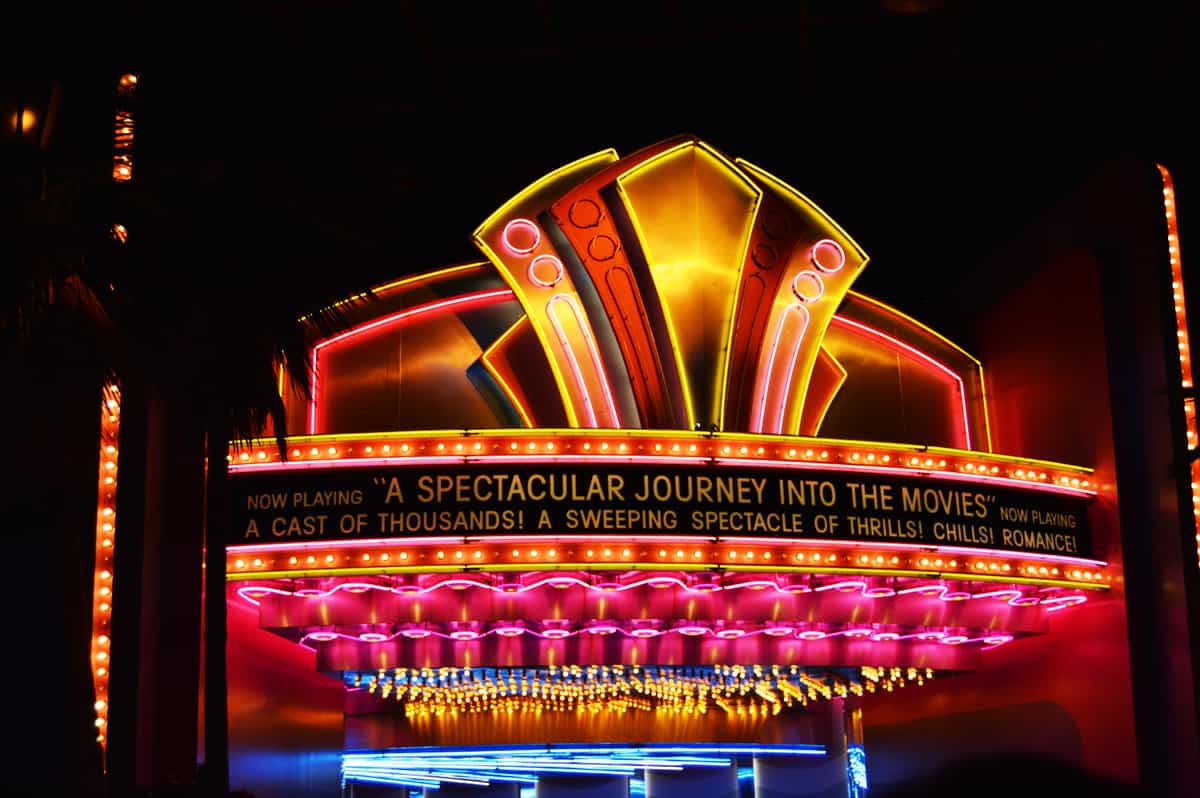 Neon marquee glows “A Spectacular Journey Into the Movies,” welcoming fans to Hollywood Studios’ enchanting nighttime magic.