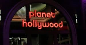 Illuminated "Planet Hollywood Observatory" sign marks the entrance; www.MickeyTips.com in corner, ideal for Disney fans.