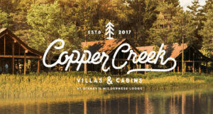 Cozy Copper Creek Villas & Cabins nestled by the water at Walt Disney World, surrounded by lush trees and vacation magic.