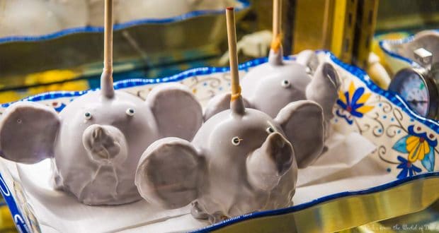 Three candy apples styled as Dumbo with big ears and trunks on a tray—must-try Disney World treats for fans of the magic.