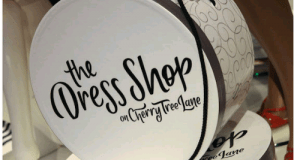 Round white box with "The Dress Shop on Cherry Tree Lane" in black script—a magical piece from Disney World's Dress Shop line.