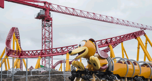 Slinky Dog Dash taking shape at Disney’s Hollywood Studios, with vibrant red tracks, yellow supports, and a construction crane nearby.