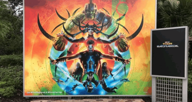 Vibrant "Thor: Ragnarok" poster with main Marvel heroes and cosmic flair, a must-see for fans exploring Disney Springs.