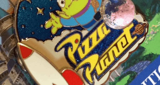 Pizza Planet pin from Toy Story featuring a green alien, rocket, and planet on a starry blue background—perfect for Disney fans.