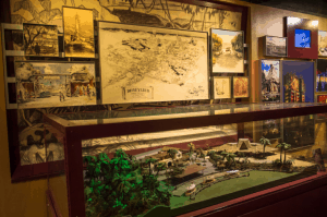 Showcase featuring a Disneyland miniature, Imagineering sketches, and classic Disney park photos, with Walt Disney World images.