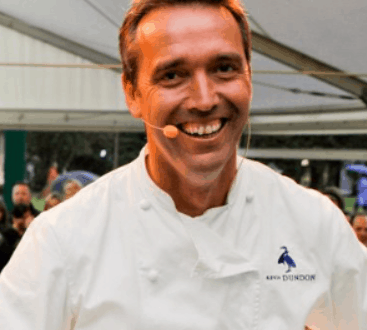 Chef Kevin Dundon greets fans with a smile at Raglan Road’s event tent in Walt Disney World, wearing his signature chef jacket.