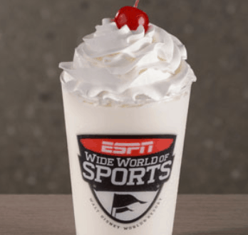 Vanilla milkshake with whipped cream and a cherry in an ESPN Wide World of Sports cup at Walt Disney World.