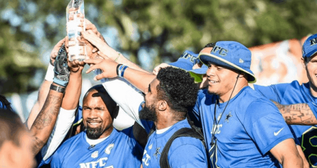 NFL Pro Bowl Week brings the excitement as NFC stars in blue jerseys hoist a trophy, celebrating like champions at a live event.