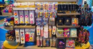 Disney Parks display of vibrant themed pens, notebooks, bookmarks, and stickers—top gift picks for fans and collectors.