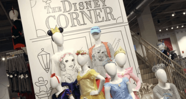 Disney princess mannequins welcome guests in front of “The Disney Corner” sign at Disney Springs.