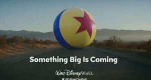 The Pixar ball floats over Toy Story Land’s road with “Something Big Is Coming” and the Walt Disney World logo underneath.