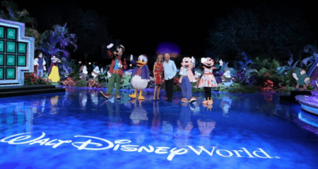 Mickey Mouse, Disney friends, and performers celebrate Walt Disney World's 35th Anniversary on a glowing stage.