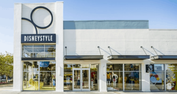 DisneyStyle storefront at Disney World with bold logo and glass doors, offering park-exclusive merch from May 12th!.