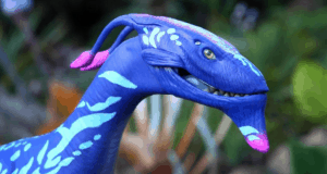 A Limited Release Pandora Banshee in vibrant blue, purple, and pink with white markings on display amid the immersive Avatar land.