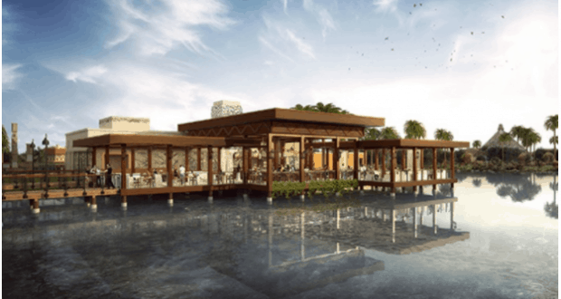 Lively lakeside Bar and Grill with outdoor seating, palm trees, and stunning reflections on Coronado Springs at Disney World.