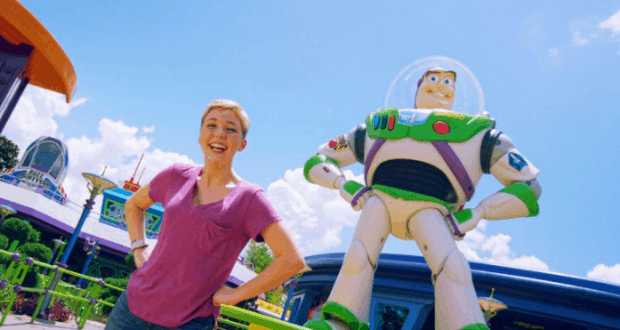 Guest smiles and poses with Buzz Lightyear at Toy Story Land in Walt Disney World, capturing a magical theme park moment.
