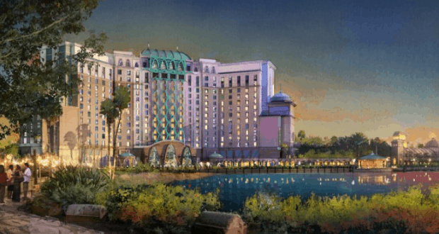 Gran Destino Tower glows with vibrant lights and lush greenery at sunset, a stunning landmark at Disney’s Coronado Springs Resort.