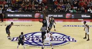 College basketball teams leap for the tip-off at center court during the AdvoCare Invitational at Walt Disney World Resort.