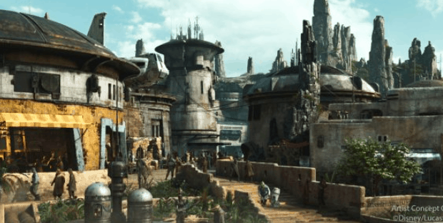Star Wars: Galaxy's Edge-inspired village with round stone buildings, rocky spires, and guests strolling under the sun.