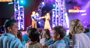 Disney on Broadway dazzles the audience with vibrant lights and songs as families enjoy the show at Walt Disney World.