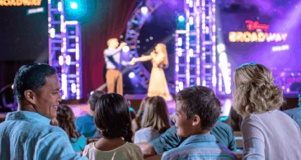 Disney on Broadway dazzles the audience with vibrant lights and songs as families enjoy the show at Walt Disney World.