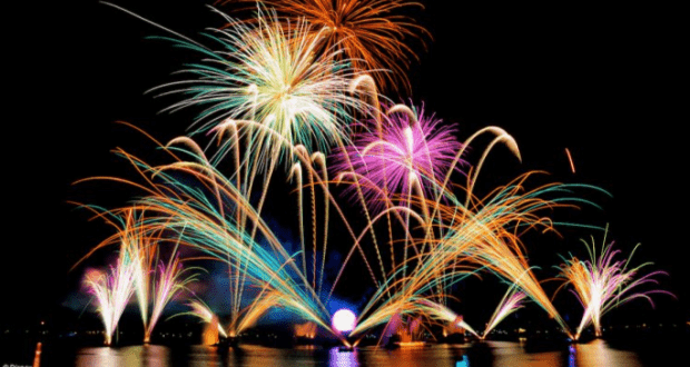 Fireworks dazzle above Epcot’s World Showcase Lagoon, their reflections lighting up the night for IllumiNations Dining guests.