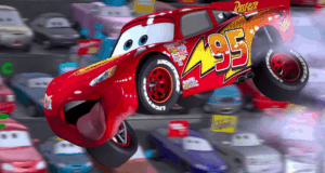 Lightning McQueen soars through the air, number 95 blazing, as fellow racers watch—just like in Lightning McQueen’s Racing Academy.
