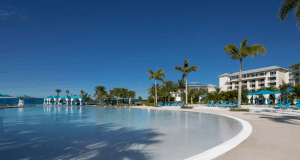Margaritaville Resort Orlando’s pool with palm trees, cabanas, and lounges—perfect for Disney fans seeking relaxation nearby.