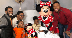 Minnie Mouse brings Disney joy to a hospital room as four adults and two kids celebrate with a transplant recipient by the bedside.