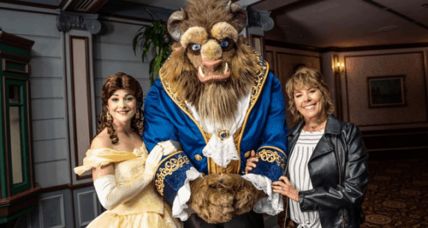 Belle and Beast join a guest in a black leather jacket for a magical photo op at Walt Disney World.