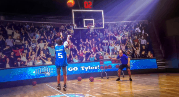 An NBA player launches a shot toward the hoop as fans cheer, bringing the thrill of live basketball to Disney Springs.