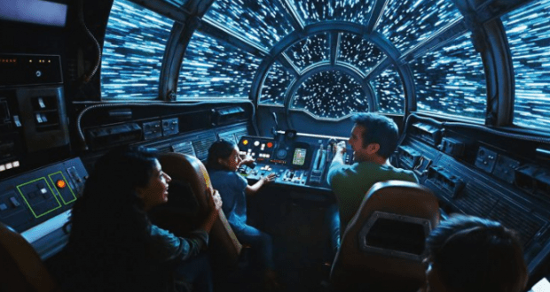 Guests aboard the Millennium Falcon ride watch blue stars streak past in the cockpit at Star Wars: Galaxy’s Edge, Disneyland.