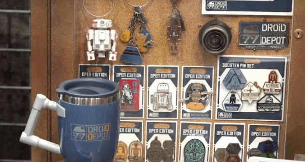 Droid Depot collectibles—blue mug, pins, keychains, and robot toys—on display at Star Wars: Galaxy’s Edge.