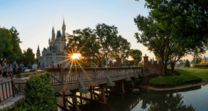 Cinderella Castle glowing at sunset with a scenic wooden bridge and lush trees, setting the stage for magical Disney moments this June 4.
