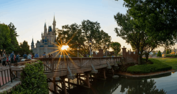 Cinderella Castle glowing at sunset with a scenic wooden bridge and lush trees, setting the stage for magical Disney moments this June 4.