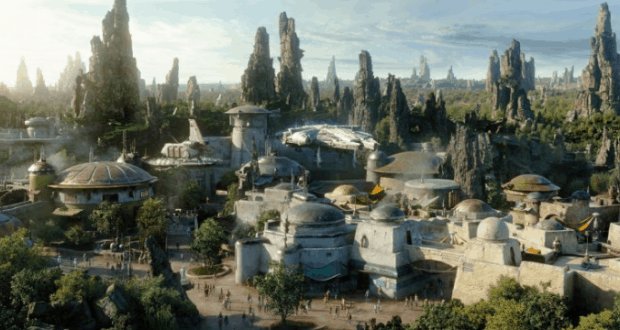 Star Wars: Galaxy’s Edge cityscape with domed buildings and spires, nestled in rocky mountains and lush greenery at Disney Parks.