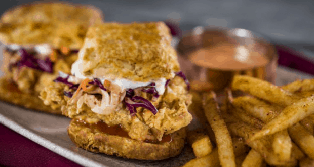 Savor a classic sandwich and crispy fries at Three Bridges Bar & Grill in Disney’s Coronado Springs Resort—theme park dining fun!.