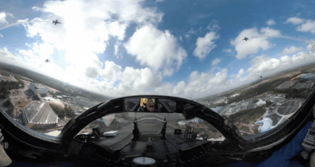 Blue Angels jets soaring in tight formation high above a bustling city, as seen from the thrilling vantage of a cockpit ride.