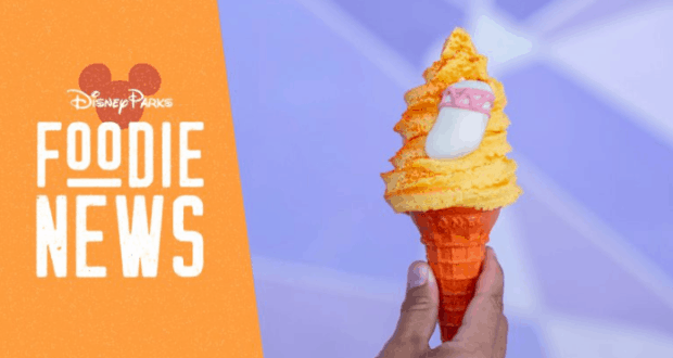 Orange soft serve in a cone with a Cinderella slipper beside a Disney Parks Foodie News sign at Magic Kingdom, Walt Disney World.