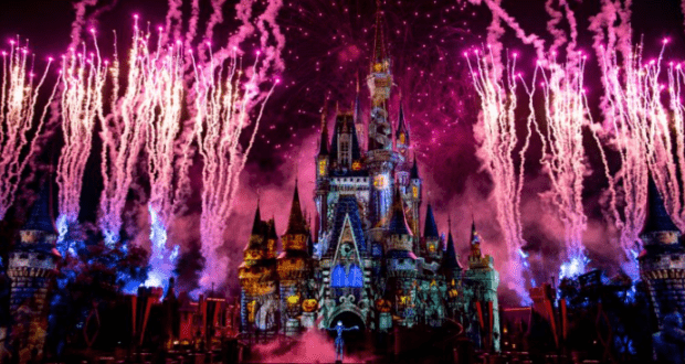 Cinderella Castle dazzles at Walt Disney World, illuminated by pink fireworks and vibrant lights in a Not So Spooky Spectacular.