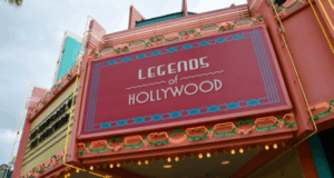 Legends of Hollywood art deco marquee in pink and teal lights up Disney’s Hollywood Studios, inviting guests inside.