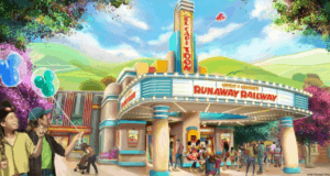 Guests gather with balloons at the vibrant Mickey & Minnie’s Runaway Railway entrance in Disneyland’s Toontown.