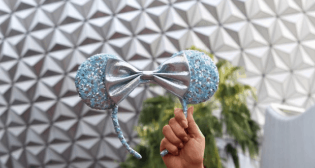 Sparkling blue and silver Minnie Mouse ears gleam against Epcot’s iconic geometric wall, radiating Disney magic.