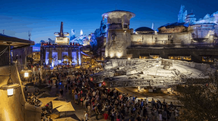 Guests explore the impressive Millennium Falcon at Star Wars: Galaxy’s Edge in Disney World during Extra Magic Hours at night.