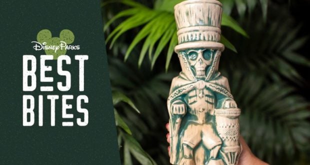 A guest shows off a skeleton top hat tiki mug at Walt Disney World’s Best Bites, October 2019—lush plants in the background.