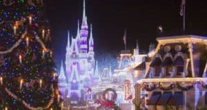 Main Street is aglow with a Christmas tree, festive lights, and the majestic Cinderella Castle sparkling during Disney World’s holidays.