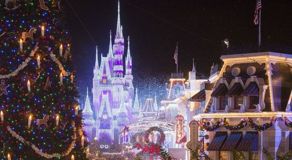 Main Street is aglow with a Christmas tree, festive lights, and the majestic Cinderella Castle sparkling during Disney World’s holidays.