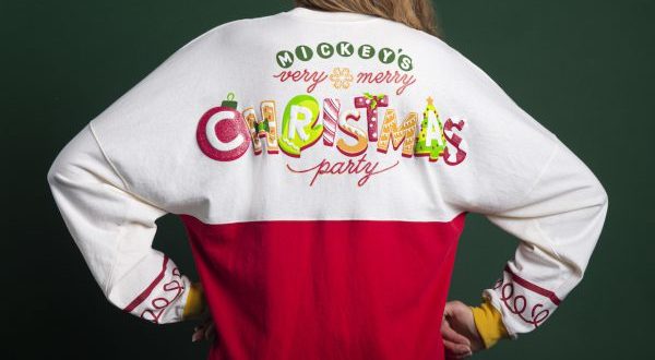 Festive Mickey's Very Merry Christmas Party shirt, iconic Disney World holiday merchandise worn by a park guest.