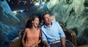 Guests enjoy a nighttime roller coaster ride through mountain peaks during Disney After Hours at Walt Disney World Resort.