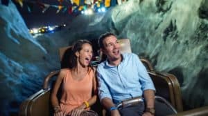 Guests enjoy a nighttime roller coaster ride through mountain peaks during Disney After Hours at Walt Disney World Resort.